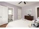 Bedroom with ceiling fan, hardwood floors, neutral color palette, and ensuite bathroom at 891 Spencer Nw St, Atlanta, GA 30314