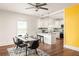 Bright dining area with modern black chairs, stylish rug, and an open view to the updated kitchen at 891 Spencer Nw St, Atlanta, GA 30314
