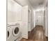 Laundry area with washer and dryer hookups in a well-lit hallway with hardwood flooring at 891 Spencer Nw St, Atlanta, GA 30314