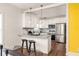 Updated kitchen with stainless steel appliances, granite countertops, breakfast bar, and modern pendant lighting at 891 Spencer Nw St, Atlanta, GA 30314