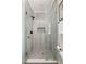 Stylish glass-enclosed shower featuring modern fixtures, neutral tile, and recessed shelving at 891 Spencer Nw St, Atlanta, GA 30314