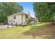 Exterior view of house showcasing a spacious backyard, raised deck, and two car garage at 1019 James Madison Ct, Mcdonough, GA 30253