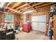 Unfinished basement area with exposed insulation and a garage door at 1019 James Madison Ct, Mcdonough, GA 30253
