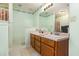 Bathroom features double sinks, large mirror, and floral accents at 1019 James Madison Ct, Mcdonough, GA 30253
