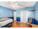 Bright bedroom with hardwood floors, comfortable seating, and ample storage at 1019 James Madison Ct, Mcdonough, GA 30253