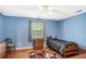 Bedroom with blue walls, hardwood floors and natural light at 1019 James Madison Ct, Mcdonough, GA 30253