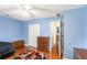 Comfortable bedroom featuring wood floors, ceiling fan, and closet at 1019 James Madison Ct, Mcdonough, GA 30253