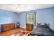 Bedroom with blue walls, hardwood floors and natural light at 1019 James Madison Ct, Mcdonough, GA 30253