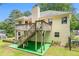 Exterior view of the house with a raised deck and stairs leading to the backyard at 1019 James Madison Ct, Mcdonough, GA 30253