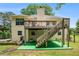 Exterior view of the house with a raised deck and stairs leading to the backyard at 1019 James Madison Ct, Mcdonough, GA 30253