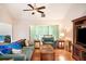 Cozy living room with hardwood floors, comfortable seating, and view of the entry and kitchen at 1019 James Madison Ct, Mcdonough, GA 30253
