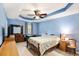Main bedroom with tray ceiling, fan, and coordinating furniture at 1019 James Madison Ct, Mcdonough, GA 30253