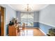 Bright home office with hardwood floors and traditional chandelier at 1019 James Madison Ct, Mcdonough, GA 30253