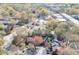 A beautiful aerial view of a red brick house surrounded by lush trees and a well-maintained landscape at 102 Defoors Mill Dr, Atlanta, GA 30318