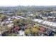 An aerial view showcases the red brick house near the cityscape and lush greenery, offering a serene and urban lifestyle at 102 Defoors Mill Dr, Atlanta, GA 30318