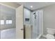 Bathroom with walk-in tiled shower, modern fixtures and storage, as well as a view to the bedroom at 102 Defoors Mill Dr, Atlanta, GA 30318
