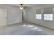 Spacious bedroom with neutral carpet, ceiling fan, and natural light from two windows at 102 Defoors Mill Dr, Atlanta, GA 30318