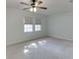 Bright bedroom featuring neutral carpet, ceiling fan, and two windows allowing ample natural light at 102 Defoors Mill Dr, Atlanta, GA 30318