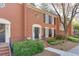 Attractive brick exterior of a multi-Gathering townhouse with well-maintained landscaping at 102 Defoors Mill Dr, Atlanta, GA 30318