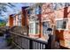 Charming brick townhome featuring a bay window and fenced front patio at 102 Defoors Mill Dr, Atlanta, GA 30318