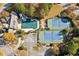 Aerial view highlighting the community pool, water slide, tennis courts, and parking areas at 2172 Haventree Ct, Lawrenceville, GA 30043