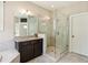 Granite vanity and glass enclosed shower in a bright bathroom with tile flooring at 2172 Haventree Ct, Lawrenceville, GA 30043