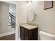 Stylish half bathroom featuring a granite countertop vanity and modern fixtures at 2172 Haventree Ct, Lawrenceville, GA 30043