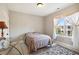 Cozy bedroom with a bed, side table, and window with sheer curtains and nice view at 2172 Haventree Ct, Lawrenceville, GA 30043
