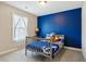 Charming bedroom with a bed and navy blue accent wall, creating a cozy space at 2172 Haventree Ct, Lawrenceville, GA 30043
