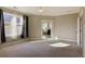 A large bedroom with carpet, two windows, and ensuite bathroom showcasing natural light at 2172 Haventree Ct, Lawrenceville, GA 30043