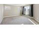 Spacious bedroom featuring neutral walls, carpet flooring and large windows with dark curtains at 2172 Haventree Ct, Lawrenceville, GA 30043