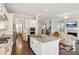 Spacious kitchen open to living room, featuring an island with granite counters and stainless appliances at 2172 Haventree Ct, Lawrenceville, GA 30043