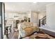 Open-concept living area showcasing the modern kitchen, hardwood floors, and access to the staircase at 2172 Haventree Ct, Lawrenceville, GA 30043