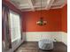 Dining area with white wainscoting, hardwood floors, modern chandelier, and natural light at 227 Shellbark Dr, Mcdonough, GA 30252