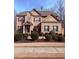 Traditional brick home featuring manicured landscaping, a gabled roof, and a welcoming front entrance at 227 Shellbark Dr, Mcdonough, GA 30252