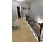 Upstairs hallway with iron-rod railing, carpet flooring, and neutral wall color at 227 Shellbark Dr, Mcdonough, GA 30252