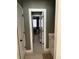 Hallway with white doors and trim leads to bedroom with carpet and window at 227 Shellbark Dr, Mcdonough, GA 30252