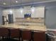 Kitchen with stone countertops, island with seating and stainless steel appliances at 227 Shellbark Dr, Mcdonough, GA 30252