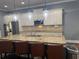 Kitchen with stone countertops, island with seating and stainless steel appliances at 227 Shellbark Dr, Mcdonough, GA 30252