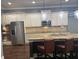 Spacious kitchen featuring stainless steel appliances, granite countertops, pendant lighting, and a center island with seating at 227 Shellbark Dr, Mcdonough, GA 30252