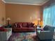 Cozy living room showcasing comfortable seating, a colorful rug, and natural light from the windows at 227 Shellbark Dr, Mcdonough, GA 30252