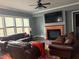 Comfortable living room showcasing a fireplace, large TV, neutral colors, and plenty of seating at 227 Shellbark Dr, Mcdonough, GA 30252