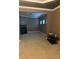 Spacious living room features plush carpeting, a fireplace, and abundant natural light from the three windows at 227 Shellbark Dr, Mcdonough, GA 30252