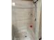 Elegant tiled shower with built-in bench, complemented by a sleek shower head at 227 Shellbark Dr, Mcdonough, GA 30252