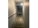 Interior staircase leading down, showcasing painted steps and a railing; needs some work and cleaning at 227 Shellbark Dr, Mcdonough, GA 30252