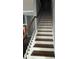 Interior staircase with carpeted treads, decorative metal spindles and a wooden handrail at 227 Shellbark Dr, Mcdonough, GA 30252