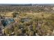 Picturesque aerial shot of the neighborhood highlighting golf course and tennis courts surrounded by trees at 615 Collier Nw Rd, Atlanta, GA 30318