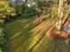 Expansive backyard with lush lawn, mature trees, and a playset, perfect for outdoor activities and relaxation at 615 Collier Nw Rd, Atlanta, GA 30318