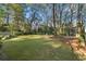 This expansive backyard offers a lush lawn, mature trees, and ample space for outdoor enjoyment at 615 Collier Nw Rd, Atlanta, GA 30318