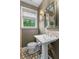 Bathroom featuring pedestal sink, lovely patterned floors, natural light, and neutral wall color at 615 Collier Nw Rd, Atlanta, GA 30318